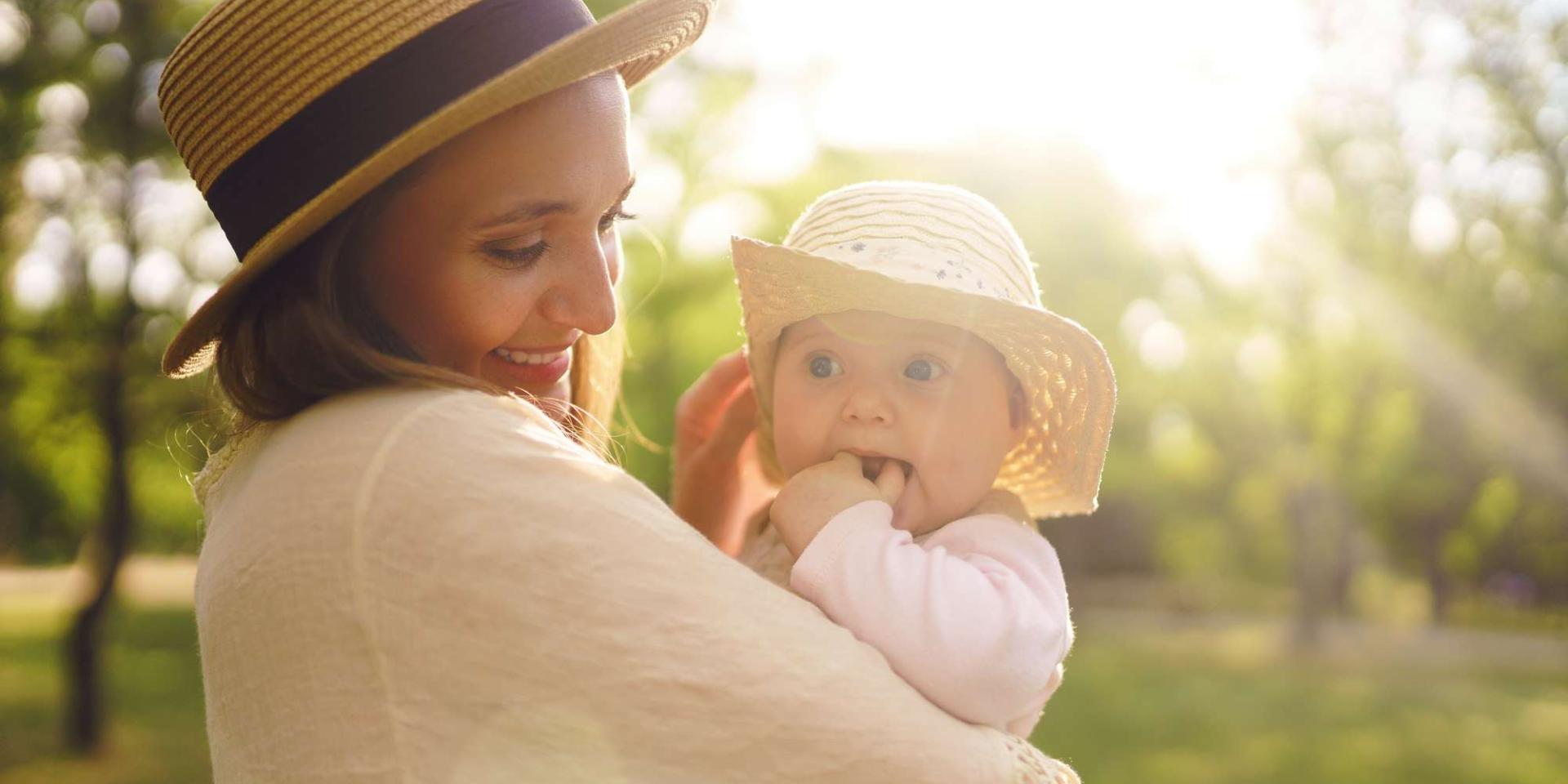 Happy stylish and loving family. mother playing with her baby ou