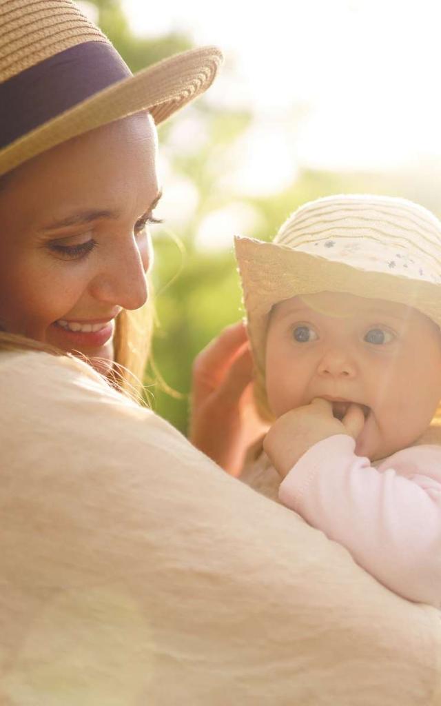 Happy stylish and loving family. mother playing with her baby