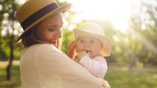 Happy stylish and loving family. mother playing with her baby