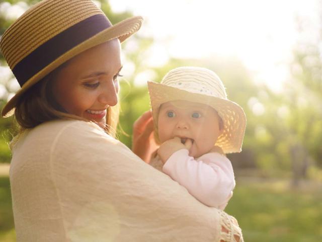 Happy stylish and loving family. mother playing with her baby