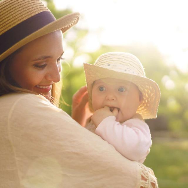 Happy stylish and loving family. mother playing with her baby