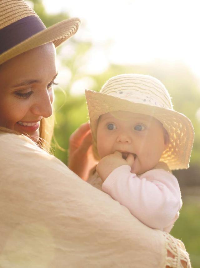 Happy stylish and loving family. mother playing with her baby